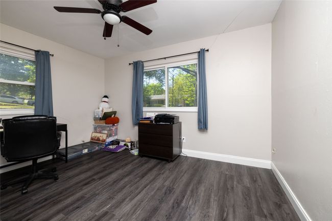 Office area featuring ceiling fan, dark wood-style flooring, and baseboards | Image 31
