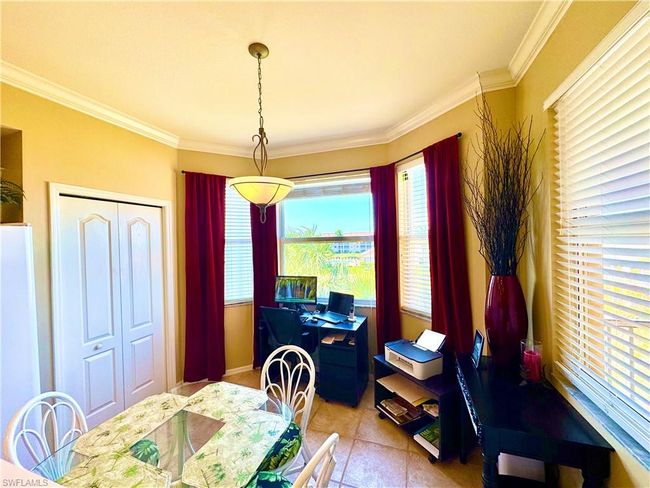 Dining room with a wealth of natural light and crown molding | Image 8