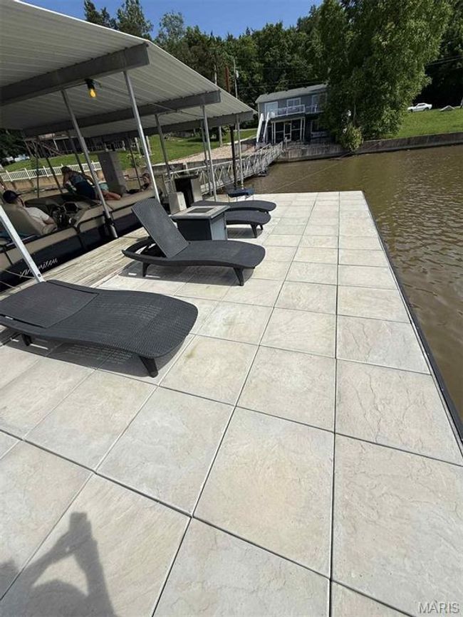View of patio with a boat dock and a water view | Image 12