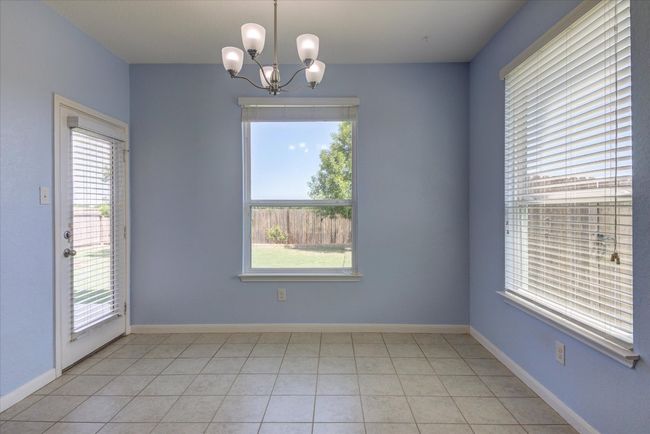 Dining space with a view of the gracious backyard and abundant natural lighting. | Image 15