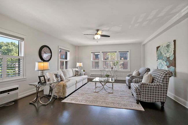 Large living room space with windows overlooking Western Avenue and looking North. | Image 11