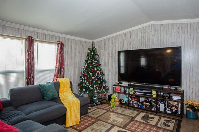 Living room with hardwood / wood-style flooring, ornamental molding, and vaulted ceiling | Image 4