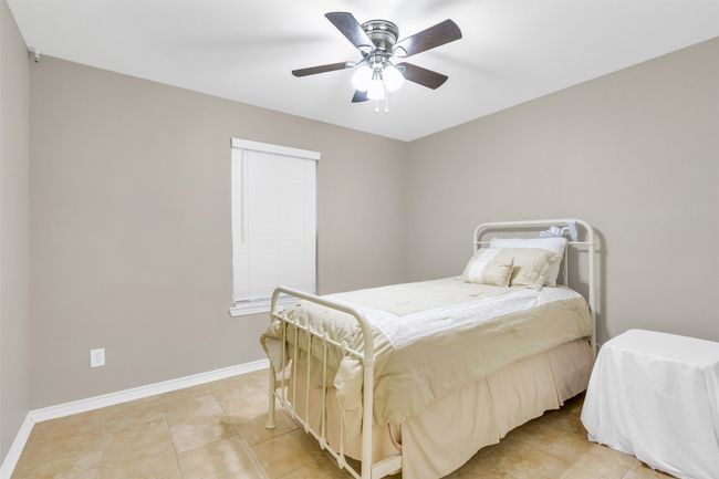 Bedroom featuring light tile patterned floors and ceiling fan | Image 11