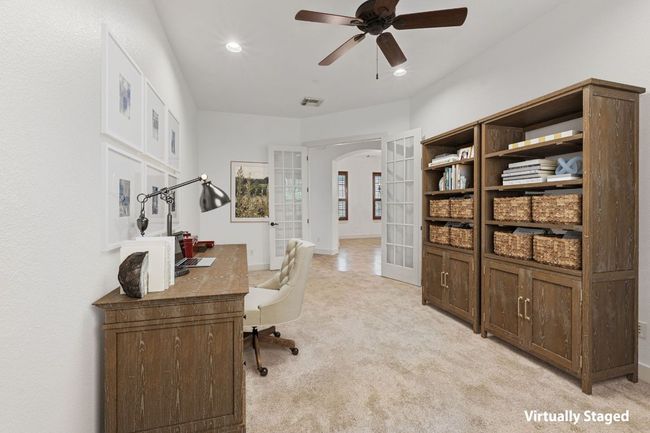 Office space with arched walkways, french doors, light colored carpet, ceiling fan, and recessed lighting | Image 9