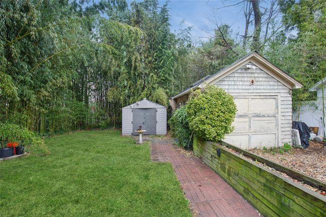 View of yard with a garage, a storage shed, and an outdoor structure | Image 27
