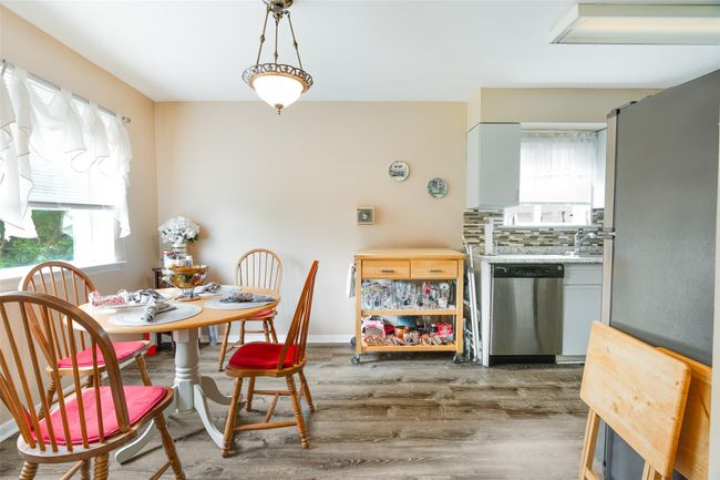 Dining area with wood finished floors and baseboards | Image 6