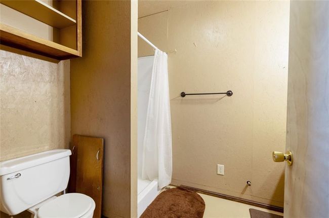 Bathroom featuring toilet and a shower stall | Image 26
