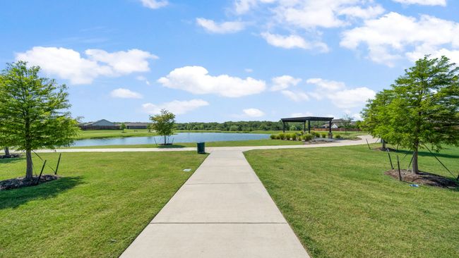View of property's community featuring a water view, a yard, and a gazebo | Image 28