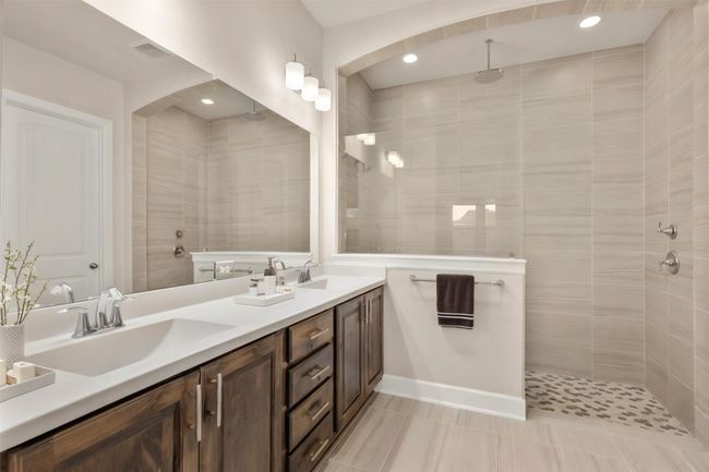 Bathroom featuring double vanity, a walk in shower, recessed lighting, and tile patterned floors | Image 20