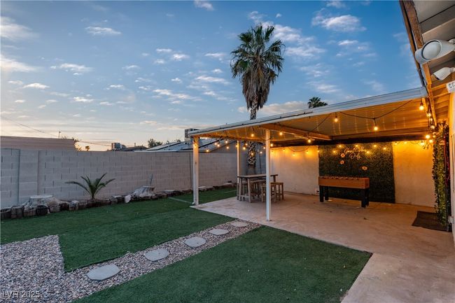 View of yard featuring a fenced backyard and a patio area | Image 46