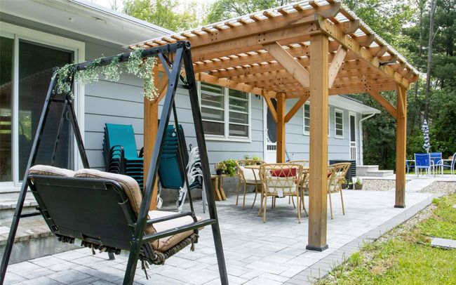 View of patio featuring a pergola and outdoor dining area | Image 10