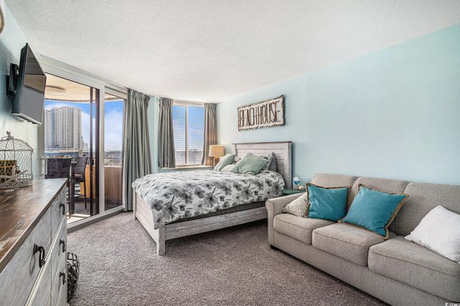 Carpeted bedroom featuring access to exterior and a textured ceiling | Image 19