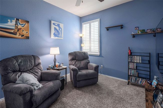 Living area featuring carpet floors, a ceiling fan, and baseboards | Image 21