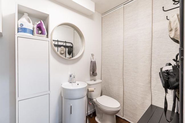 Full bath with toilet, wood finished floors, vanity, and curtained shower | Image 12