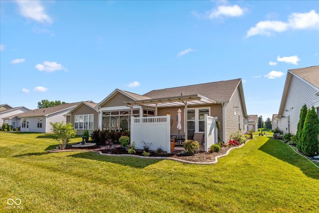 rear view of house featuring covered patio and 3 season sunroom | Image 7