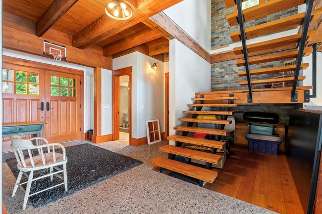 Foyer entrance with wooden ceiling with exposed beams, french doors, and baseboards | Image 4