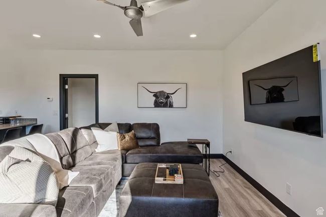 Living area featuring recessed lighting, light wood-type flooring, a ceiling fan, and baseboards | Image 26