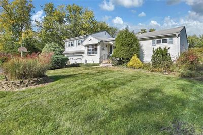 front of property with yard and a garage | Image 2