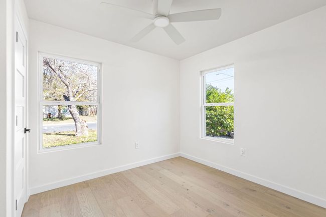 Unfurnished room featuring light wood-type flooring, healthy amount of natural light, and a ceiling fan | Image 24