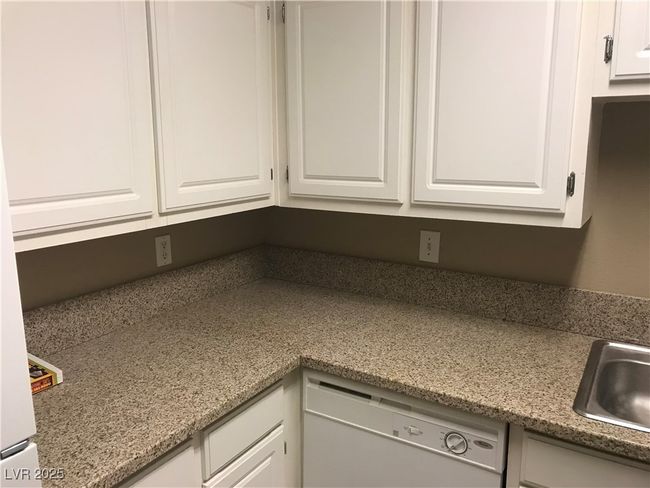 Kitchen view of dishwasher and white cabinets | Image 5