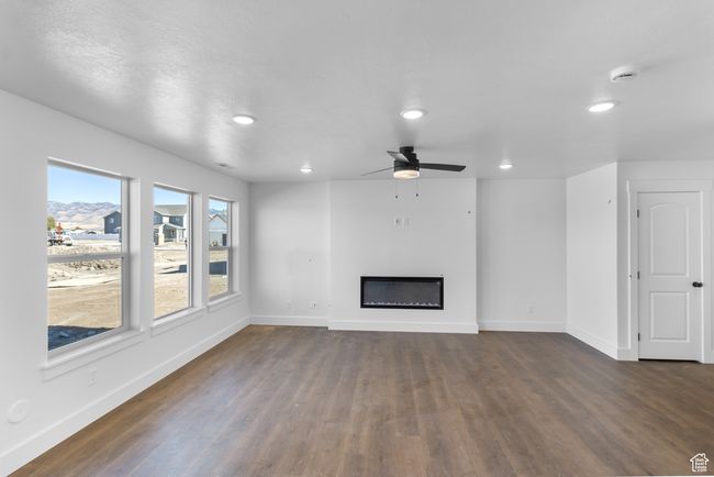 (Picture of Previously Build Home) Great Room w/ Electric Fireplace, Ceiling Fan & Laminate Floors | Image 5