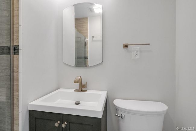 Bathroom with vanity, a tile shower, and toilet | Image 23
