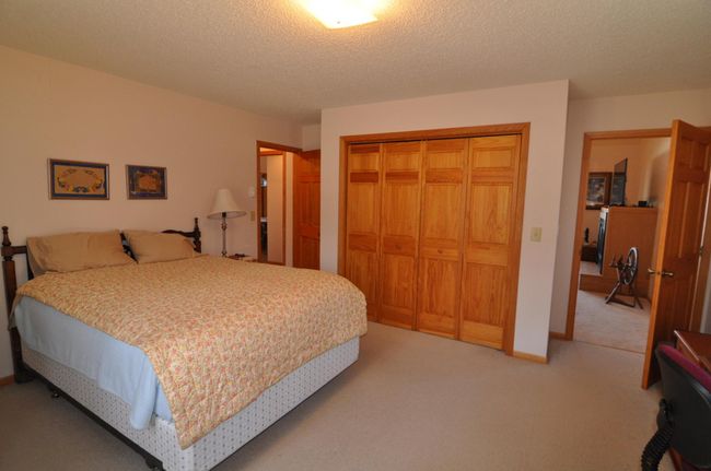 Main level bedroom has nice closet, door to left leads to laundry and bathroom | Image 27