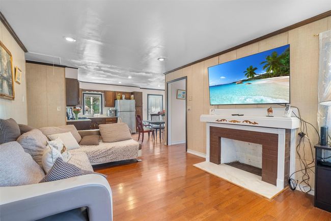 Living room featuring light wood-style floors, recessed lighting, and crown molding | Image 15