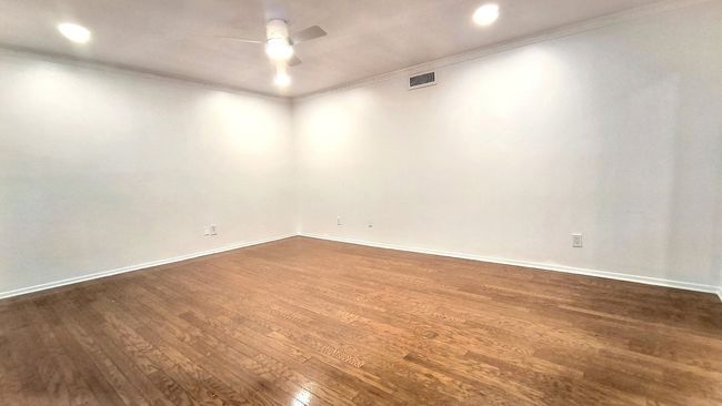 Spare room with dark wood-type flooring, ornamental molding, and ceiling fan | Image 6