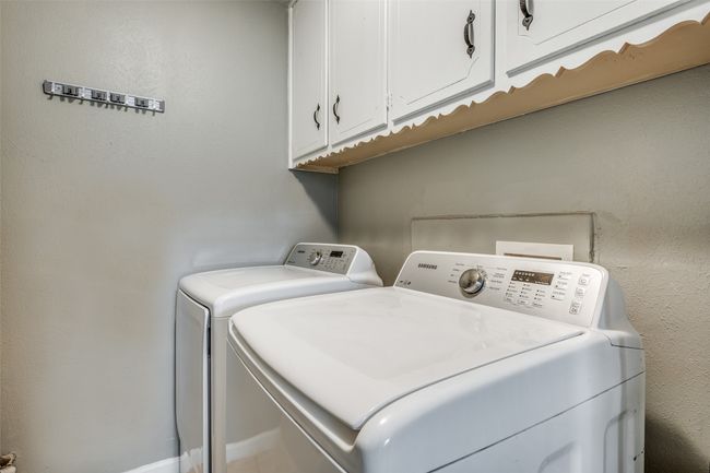 Laundry area with independent washer and dryer and cabinet space | Image 23