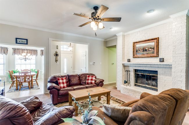Enjoy cozy nights by the fire in the spacious living room. | Image 6