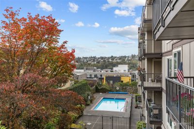 Welcome home to your oasis in the middle of the city! Views from your private patio / courtyard overlook a stunning pool and Magnolia beyond. This is one of only two units with access to this outdoor area. | Image 1