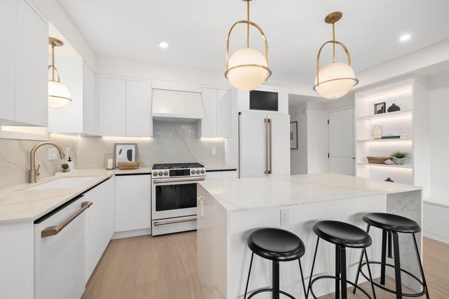 Kitchen featuring a sink, light wood-type flooring, custom exhaust hood, white appliances, and open shelves | Image 8