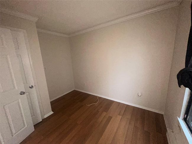 Unfurnished room featuring wood finished floors and crown molding | Image 7