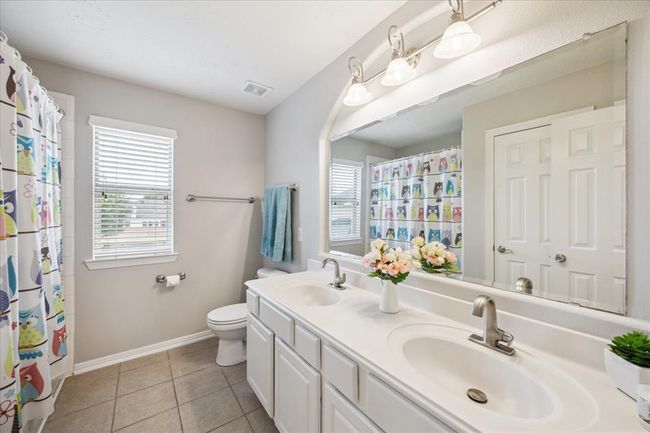 Third bathroom with double vanity. | Image 44