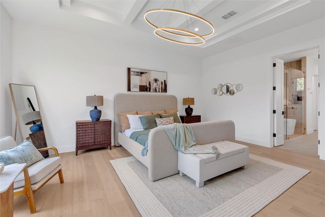 Bedroom with a chandelier, light wood-style flooring, and beamed ceiling | Image 21
