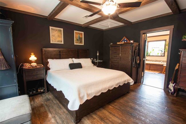 Master Bedroom with coffered ceiling, wood finished floors, beamed ceiling, a ceiling fan, and ensuite bathroom | Image 14