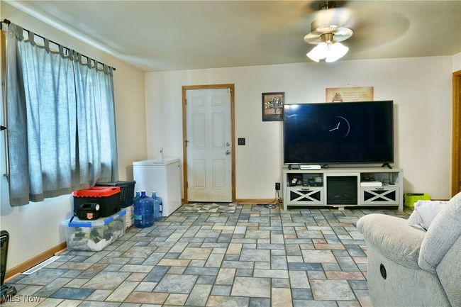 Living room featuring baseboards and a ceiling fan | Image 13