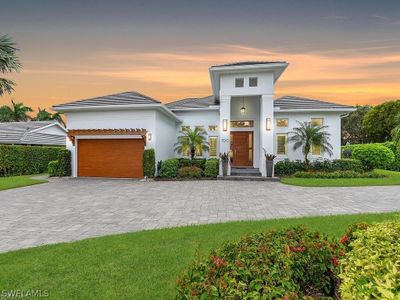 View of front facade featuring a garage and a yard | Image 1