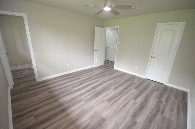 Another view of the owners retreat where you can see the walk-in closet on the right and suite bathroom on the left. | Image 19