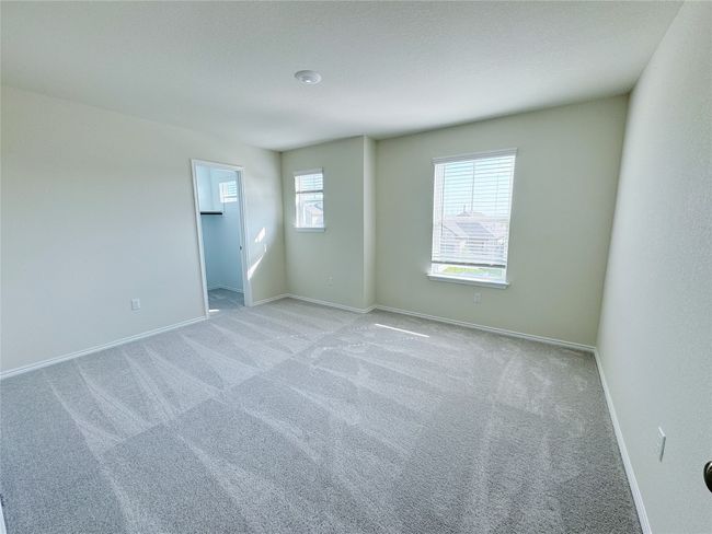 Spare room with light colored carpet and baseboards | Image 24