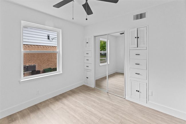 Unfurnished bedroom featuring a closet, light wood-type flooring, baseboards, and a ceiling fan | Image 18