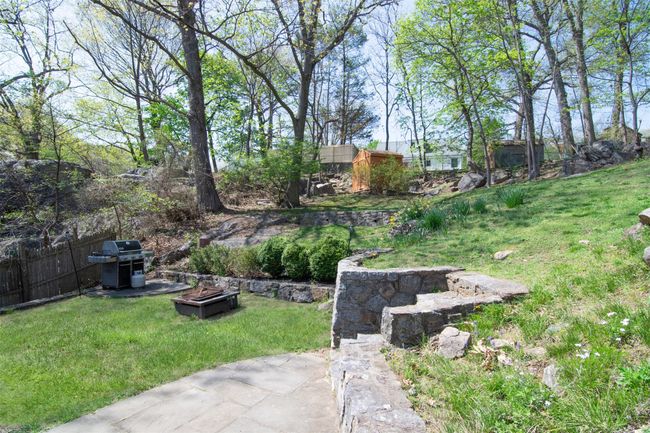 View of yard featuring a fire pit and fence | Image 23