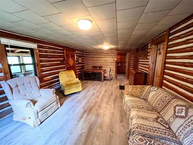 Living area featuring wood finished floors and log walls | Image 13