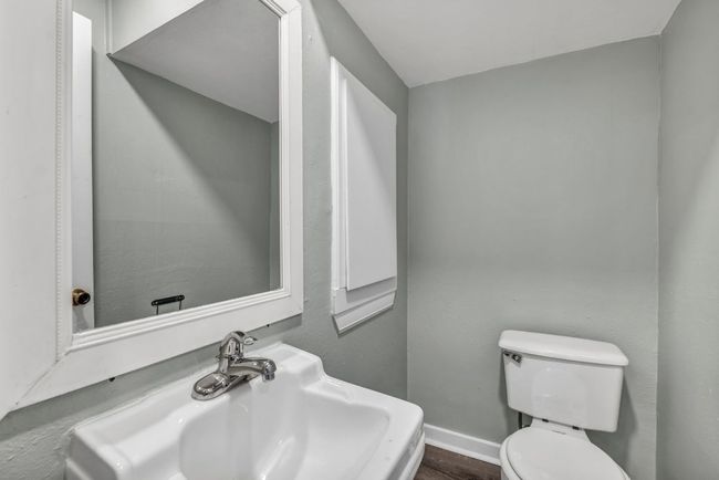 Half bath featuring toilet, a sink, and baseboards | Image 9