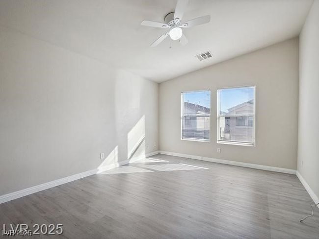 Unfurnished room with wood finished floors, a ceiling fan, and vaulted ceiling | Image 16
