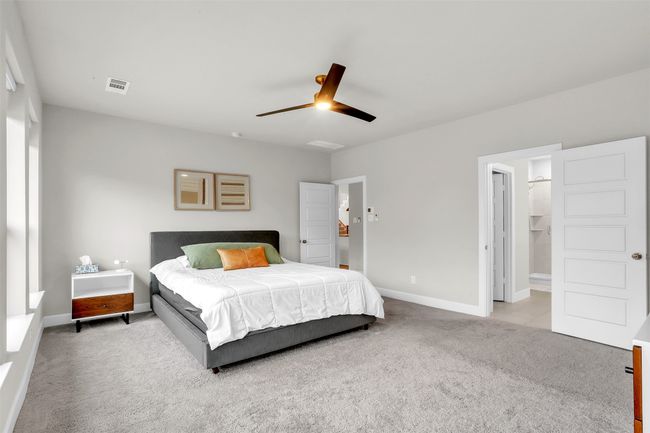 Carpeted bedroom featuring visible vents, baseboards, and a ceiling fan | Image 15