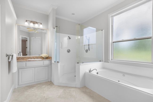 Unwind in this elegant primary bathroom complete with a deep spa tub, large walk-in shower! | Image 16