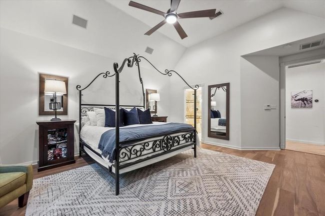 The spacious primary suite is a peaceful retreat with soaring ceilings, wood floors, and a private seating area that opens to the backyard. | Image 21