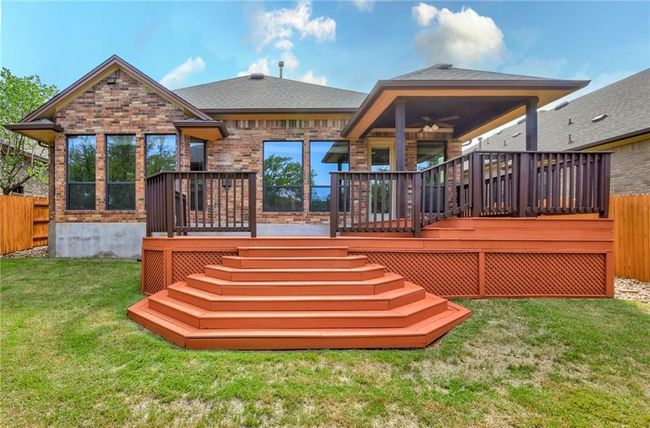 Back of property with ceiling fan, stairway, a deck, and brick siding | Image 33